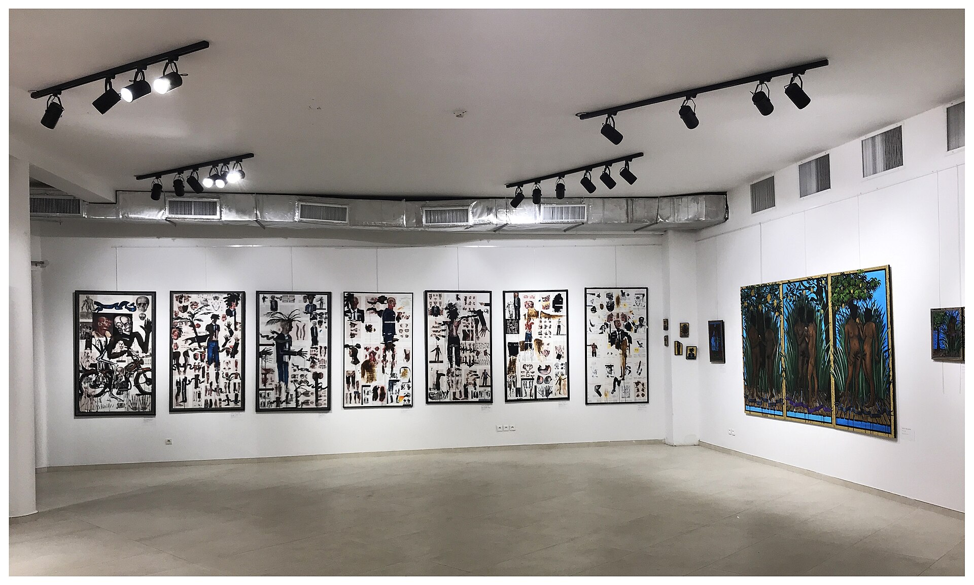 An art gallery displays a series of black and white drawings and paintings, showcasing fandom inspired contemporary art.