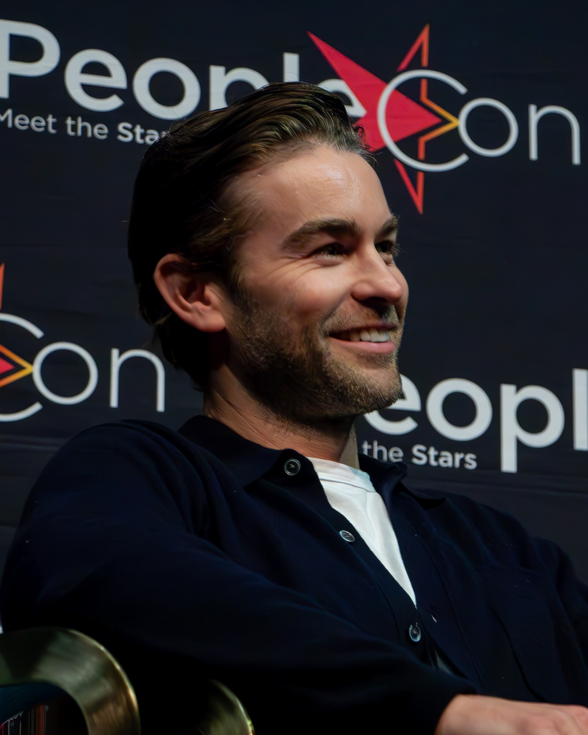Jared Padalecki smiles at a panel during PeoriaCon, showcasing the excitement of fan conventions.